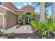 Inviting front entrance with a fountain feature, lush landscaping, and a stylish, glass-paneled front door at 7626 Double Pine Dr, Sarasota, FL 34240