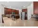Gourmet kitchen features an island, pendant lighting, stainless steel refrigerator, and dark wood cabinets at 7626 Double Pine Dr, Sarasota, FL 34240