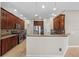Spacious kitchen boasts stainless steel appliances, a breakfast bar, and wooden cabinetry at 7626 Double Pine Dr, Sarasota, FL 34240