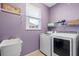 Purple laundry room features newer washer and dryer, sink, and window with natural light at 7626 Double Pine Dr, Sarasota, FL 34240