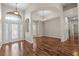 Bright living room featuring an open layout, hardwood floors, high ceilings, and elegant light fixtures at 7626 Double Pine Dr, Sarasota, FL 34240