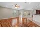 Open concept living room with hardwood floors, kitchen access, and outdoor patio access at 7626 Double Pine Dr, Sarasota, FL 34240