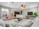 Bright, open-concept living room featuring hardwood floors and seamless flow to the kitchen and outdoor patio at 7626 Double Pine Dr, Sarasota, FL 34240