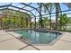 A screened in pool with lush tropical landscaping at 7626 Double Pine Dr, Sarasota, FL 34240
