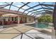 Spacious outdoor living area includes a screened pool with seating at 7626 Double Pine Dr, Sarasota, FL 34240