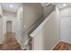 Interior staircase showcases neutral walls and trim and wood laminate flooring in the hallway and entry at 7626 Double Pine Dr, Sarasota, FL 34240