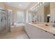 Luxurious primary bathroom with a soaking tub, walk-in shower, and double vanity at 7821 Troon Ct, Lakewood Ranch, FL 34202