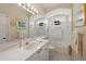 The bathroom features a shower-tub combo, double-sink vanity and an arched ceiling at 7821 Troon Ct, Lakewood Ranch, FL 34202