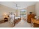 Cozy bedroom featuring natural light, ceiling fan and ample closet space at 7821 Troon Ct, Lakewood Ranch, FL 34202