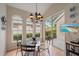 Casual dining area featuring a glass table and a sliding glass door to the patio at 7821 Troon Ct, Lakewood Ranch, FL 34202