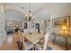 Formal dining room with chandelier, open to living areas and bright kitchen at 7821 Troon Ct, Lakewood Ranch, FL 34202