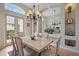 Dining room with mirrored wall, chandelier, and French door access to yard at 7821 Troon Ct, Lakewood Ranch, FL 34202
