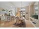Elegant dining room with chandelier and adjacent kitchen with breakfast bar at 7821 Troon Ct, Lakewood Ranch, FL 34202