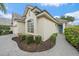 Beautiful home with manicured landscaping and a paver walkway leading to the charming blue front door at 7821 Troon Ct, Lakewood Ranch, FL 34202