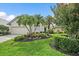 Beautiful single-story house with a blue door, a two car garage and landscaping at 7821 Troon Ct, Lakewood Ranch, FL 34202