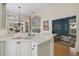 Open kitchen view with breakfast bar and view of formal dining and living room areas at 7821 Troon Ct, Lakewood Ranch, FL 34202