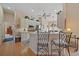 Bright kitchen with breakfast bar and stainless steel appliances, flowing seamlessly into other living areas at 7821 Troon Ct, Lakewood Ranch, FL 34202