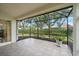 This covered lanai offers a tiled floor, screened enclosure, and a peaceful view of the landscaped backyard at 7821 Troon Ct, Lakewood Ranch, FL 34202