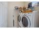 A bright laundry room with washer, dryer, shelving and cabinets at 7821 Troon Ct, Lakewood Ranch, FL 34202