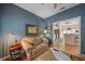 Cozy living room with blue walls, hardwood floors and view into kitchen at 7821 Troon Ct, Lakewood Ranch, FL 34202