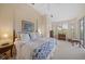 Spacious main bedroom featuring plush carpeting, a ceiling fan, and large windows for natural light at 7821 Troon Ct, Lakewood Ranch, FL 34202