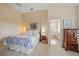 Bright main bedroom featuring soft carpet, a ceiling fan, and an ensuite bathroom at 7821 Troon Ct, Lakewood Ranch, FL 34202