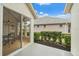 Outdoor patio area with view of dining area and lush landscaping at 7821 Troon Ct, Lakewood Ranch, FL 34202