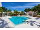 Resort-style pool featuring ample seating, palm trees and a covered cabana for relaxing in this beautiful outdoor oasis at 7821 Troon Ct, Lakewood Ranch, FL 34202