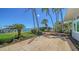 The lush backyard features a patio, green grass, and dock access for relaxing waterfront living at 878 Freeling Dr, Sarasota, FL 34242