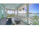 Relax on this charming tiled balcony with serene waterfront views and comfortable seating at 878 Freeling Dr, Sarasota, FL 34242