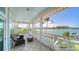 Charming tiled balcony with wicker furniture overlooking the water, providing a relaxing outdoor space at 878 Freeling Dr, Sarasota, FL 34242