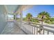 Screened balcony showing the driveway, palm trees, and clear blue skies at 878 Freeling Dr, Sarasota, FL 34242
