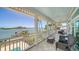 This waterfront balcony features tile flooring, comfortable seating, and stunning water views at 878 Freeling Dr, Sarasota, FL 34242