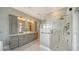 Spacious bathroom featuring a modern shower, double sinks, and marble tile floors at 878 Freeling Dr, Sarasota, FL 34242