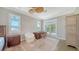 Bright bedroom with a wooden desk, chair, and a ceiling fan for comfortable living at 878 Freeling Dr, Sarasota, FL 34242