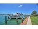 Picturesque private boat dock with a lift showcases the beauty of waterfront living and serene water views at 878 Freeling Dr, Sarasota, FL 34242