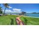 Scenic waterfront view featuring a private boat dock with a lift and a charming red brick pathway at 878 Freeling Dr, Sarasota, FL 34242