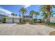 Charming two-story home with lush landscaping, a three-car garage, and a welcoming brick path at 878 Freeling Dr, Sarasota, FL 34242