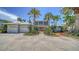 Charming two-story home with lush landscaping, a three-car garage, and a welcoming brick path at 878 Freeling Dr, Sarasota, FL 34242