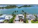 Gorgeous waterfront home featuring lush landscaping, multiple boat docks, and a sparkling swimming pool at 878 Freeling Dr, Sarasota, FL 34242
