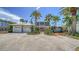 Charming two-story home with lush landscaping, a three-car garage, and a welcoming brick path at 878 Freeling Dr, Sarasota, FL 34242