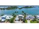 Gorgeous waterfront home featuring lush landscaping, multiple boat docks, and a sparkling swimming pool at 878 Freeling Dr, Sarasota, FL 34242
