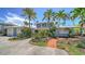 Charming two-story home with lush landscaping, a three-car garage, and a welcoming brick path at 878 Freeling Dr, Sarasota, FL 34242