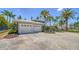 Spacious three-car garage with ample parking space and a beautiful landscaped yard at 878 Freeling Dr, Sarasota, FL 34242