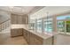 Bright kitchen with stone countertops, stainless steel appliances, an island, and water views at 878 Freeling Dr, Sarasota, FL 34242