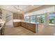 Open kitchen with island, custom cabinets, stainless appliances, and views of the pool and bay at 878 Freeling Dr, Sarasota, FL 34242