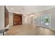 Spacious living room with hardwood floors, built-in cabinet, and glass doors at 878 Freeling Dr, Sarasota, FL 34242