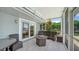 Screened patio with comfortable wicker seating and a stylish fire pit table for outdoor entertaining at 878 Freeling Dr, Sarasota, FL 34242