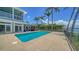 This pool and patio area offers stunning water views, with lush landscaping and comfortable seating at 878 Freeling Dr, Sarasota, FL 34242