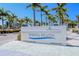 Siesta Beach sign, a Sarasota County Park, with tall palm trees under a clear blue sky at 878 Freeling Dr, Sarasota, FL 34242